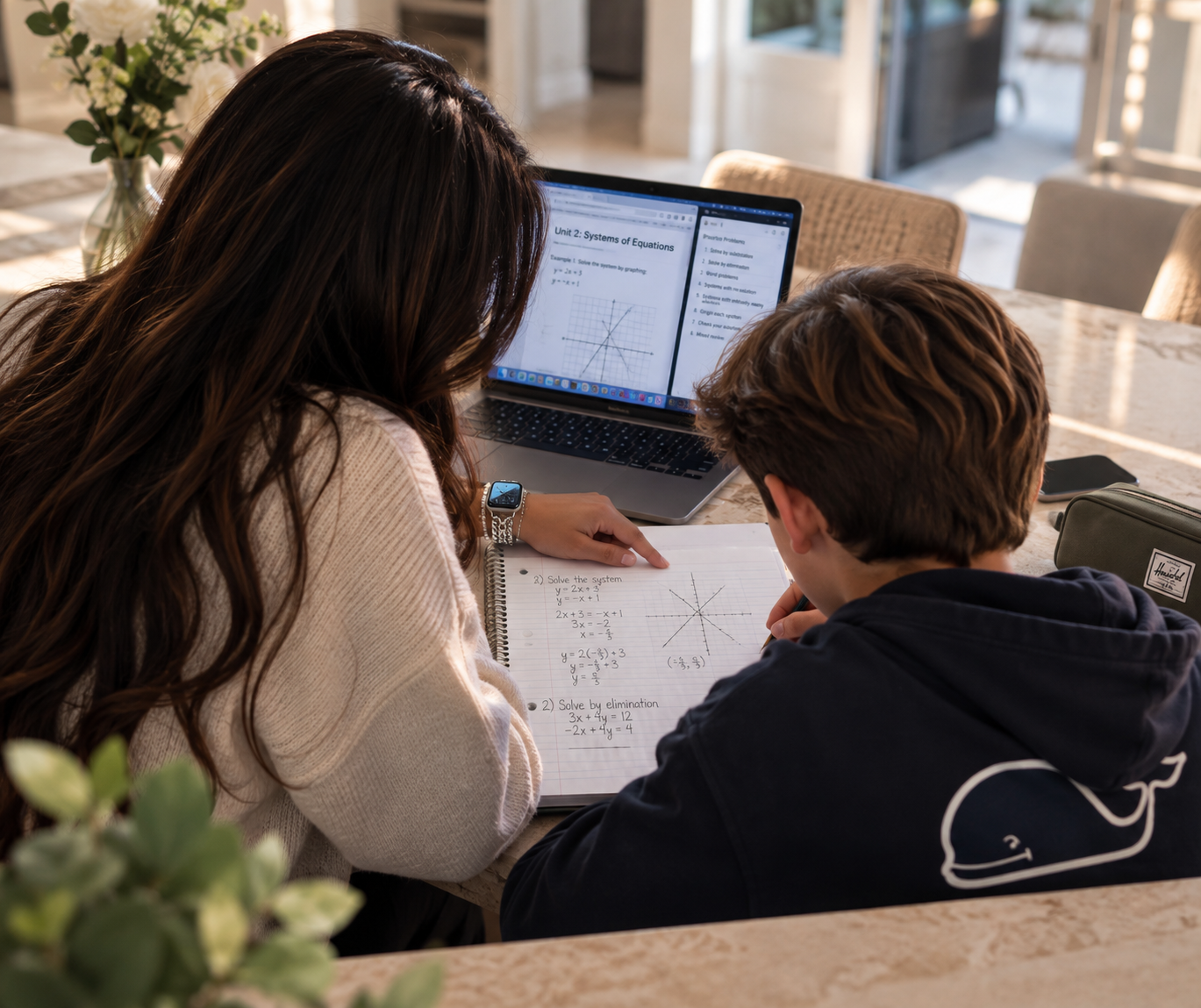 Arushi tutoring a student at a desk